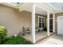 Inviting covered front porch with seating, perfect for enjoying quiet moments outdoors at 5428 Colonial Garden Dr, Huntersville, NC 28078