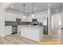 Modern kitchen featuring white cabinetry, stainless steel appliances, and granite countertops at 6009 Jasmine Branch Rd, Charlotte, NC 28216