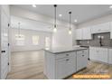 Bright, open kitchen featuring a center island and seamless flow to the living area at 6009 Jasmine Branch Rd, Charlotte, NC 28216
