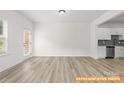 Inviting living room with modern flooring and plenty of natural light at 6009 Jasmine Branch Rd, Charlotte, NC 28216