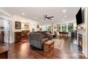 Spacious open-concept living room featuring hardwood floors, fireplace, and ample natural light at 8737 Mullis Forest Ct, Mint Hill, NC 28227