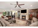 Inviting living room boasts a fireplace, ceiling fan, hardwood floors, and comfortable seating at 8737 Mullis Forest Ct, Mint Hill, NC 28227
