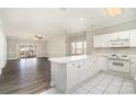 Open floor plan with kitchen island flowing into a spacious living room with a sliding door to balcony at 8969 Meadow Vista Rd, Charlotte, NC 28213