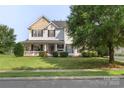 Inviting two-story home featuring a well-maintained lawn and mature trees at 9008 Magna Ln, Indian Trail, NC 28079