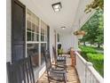Cozy front porch with rocking chairs, perfect for relaxing and enjoying the neighborhood at 9008 Magna Ln, Indian Trail, NC 28079