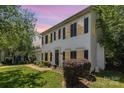 Attractive two-story home with manicured lawn, enhanced by lush landscaping and mature trees, offering a welcoming ambiance at 9107 Royal Highlands Ct, Charlotte, NC 28277