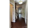 Inviting entryway with hardwood floors, staircase with white railing, and neutral wall paint at 9593 Camberley Nw Ave, Concord, NC 28027