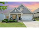 Charming single-Gathering home featuring a manicured front yard, two-car garage, and inviting front porch at 10016 St Kitts Landing Ln, Charlotte, NC 28278