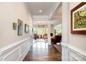 Elegant hallway with hardwood floors that lead to a bright living area with large windows at 10016 St Kitts Landing Ln, Charlotte, NC 28278