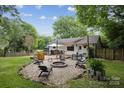 Spacious backyard with a fire pit, deck, and stylish seating, perfect for outdoor entertaining at 1021 Nancy Dr, Charlotte, NC 28211