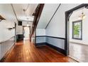 Spacious hallway featuring beautiful wood floors, decorative trim, and a staircase leading to the upper level at 107 Hinton St, Chester, SC 29706