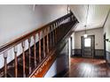 Detailed view of the staircase with dark wood railing and trim at 107 Hinton St, Chester, SC 29706