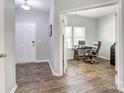 Inviting entryway showcasing wood flooring and open access to a bright office space at 1077 River Haven Sw Ave, Concord, NC 28025