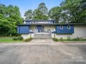 Stylish blue two-story home with clerestory windows, gray brickwork, and landscaped front yard at 1261 Westbrook Cir, Gastonia, NC 28052