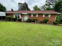 Traditional brick home featuring well-manicured landscaping, offering curb appeal at 13427 Homewood Dr, Charlotte, NC 28262