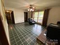 Cozy living room boasts checkered tile flooring and natural light at 13427 Homewood Dr, Charlotte, NC 28262