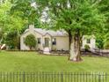 Charming single-story home with a well-manicured lawn and beautiful landscaping with a walkway leading to the front door at 138 Shepherd Rd, Mooresville, NC 28115