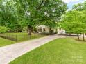 Beautifully landscaped home with a long driveway and fenced yard at 138 Shepherd Rd, Mooresville, NC 28115