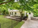 Charming single-story home with a well-manicured lawn and beautiful landscaping and a fenced yard at 138 Shepherd Rd, Mooresville, NC 28115