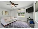 Well-lit living area with a gray sofa, neutral decor, and large windows providing ample natural light at 13821 David St, Huntersville, NC 28078