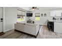 Bright living room featuring modern furnishings, a ceiling fan, and an adjacent kitchen area at 13821 David St, Huntersville, NC 28078