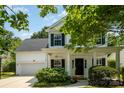 Charming two-story home with a covered front porch, black shutters, and manicured landscaping at 16121 Wrights Ferry Rd, Charlotte, NC 28278