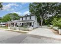 A quaint two-story house featuring a classic white picket fence and a spacious driveway at 215 S Shaver St, Salisbury, NC 28144