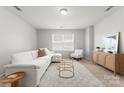 A bright living room is furnished with a white sofa and decorative gold tables on a patterned rug at 2236 Prairie Rd, Concord, NC 28027