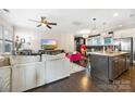 Open-concept living room and kitchen with hardwood floors and stylish furnishings at 2313 Blueberry St, Belmont, NC 28012