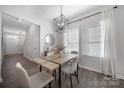 Cozy dining area with modern light fixture and neutral decor near the kitchen at 240 Briana Marie Way, Indian Trail, NC 28079