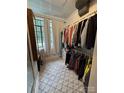 Organized walk-in closet with patterned carpet and natural light from a window at 2412 Elizabeth Ave, Shelby, NC 28150