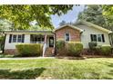 Attractive brick and siding home with a welcoming front porch and manicured shrubs at 2434 Olewoods Ct, Rock Hill, SC 29732