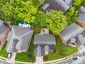 Aerial shot of a home with a wooden deck and landscaped backyard and surrounding neighborhood at 2563 Firethorn Ct, Gastonia, NC 28056