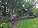 Cypress Pointe community entrance with lush greenery, manicured lawns and mature trees at 2563 Firethorn Ct, Gastonia, NC 28056