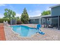 Backyard swimming pool with brick patio, lounge seating and mature landscaping at 2908 Dylan Nw Pl, Concord, NC 28027