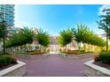 Beautifully landscaped courtyard with symmetrical walkways, vibrant flowerbeds, and mature shade trees at 300 W 5Th St # 723, Charlotte, NC 28202