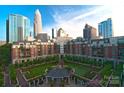 A stunning aerial view showcasing the luxury condo's courtyard, lush greenery, and uptown skyline at 300 W 5Th St # 723, Charlotte, NC 28202