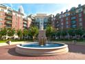 Beautiful building exterior showcasing a relaxing water fountain and lush green landscaping at 300 W 5Th St # 723, Charlotte, NC 28202
