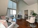 Bright living room with high ceilings, wood floors, and access to a balcony at 300 W 5Th St # 723, Charlotte, NC 28202