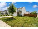 Attractive home with a green lawn, a driveway, and a cozy front porch, creating a welcoming atmosphere at 3092 Riker St, Clover, SC 29710