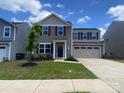 Charming two-story home featuring a well-maintained lawn and a two-car garage at 3113 Bouquet St, Charlotte, NC 28215