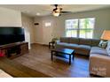 Inviting living room features new flooring, a comfortable couch, and a flat screen tv at 3113 Bouquet St, Charlotte, NC 28215