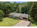 Well-maintained single-story home featuring a lovely front lawn, covered entry, and convenient carport at 312 Walton Dr, Statesville, NC 28625