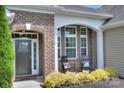 Inviting front porch with rocking chairs and decorative pillows at 317 Annatto Way, Tega Cay, SC 29708