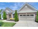 Garage door with brick accents and manicured landscaping at 317 Annatto Way, Tega Cay, SC 29708