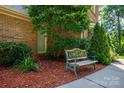 Inviting front exterior with a bench seat situated within lush landscaping with mulch at 3513 Briarcliff Acres Dr, Lincolnton, NC 28092