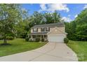 Charming two-story home featuring a well-manicured lawn, a front porch, and an attached two-car garage at 4002 Paddle Wheel Ln, Indian Trail, NC 28079