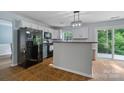 Bright kitchen featuring white cabinets, modern appliances, and an adjacent breakfast bar at 4002 Paddle Wheel Ln, Indian Trail, NC 28079