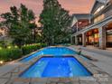 Backyard featuring a spacious pool and hot tub surrounded by lush landscaping and trees, perfect for outdoor relaxation at 4290 Barbrick St, Sherrills Ford, NC 28673