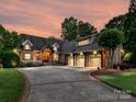 Charming home features lush landscaping, a circular driveway, and a spacious three-car garage at 4290 Barbrick St, Sherrills Ford, NC 28673